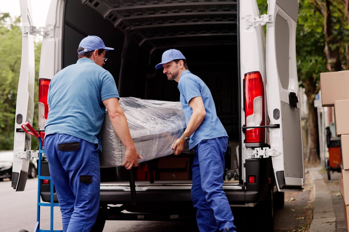 Professional movers assisting with furniture removal from a client's house